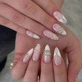 24Pcs Medium Almond Press on Nails White French Tip Nude Acrylic Fake Nails with 3D Gold Beads Rhinestone Chain Designs False Nails Luxury Elegant Full Cover Glossy Glue on Nail Manicure for Women - color: style09